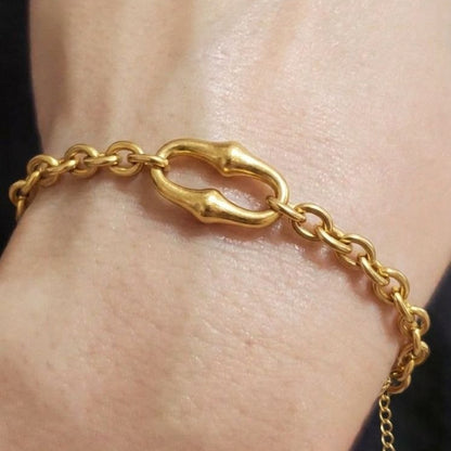 Gold bracelet on a wrist with a close-up view